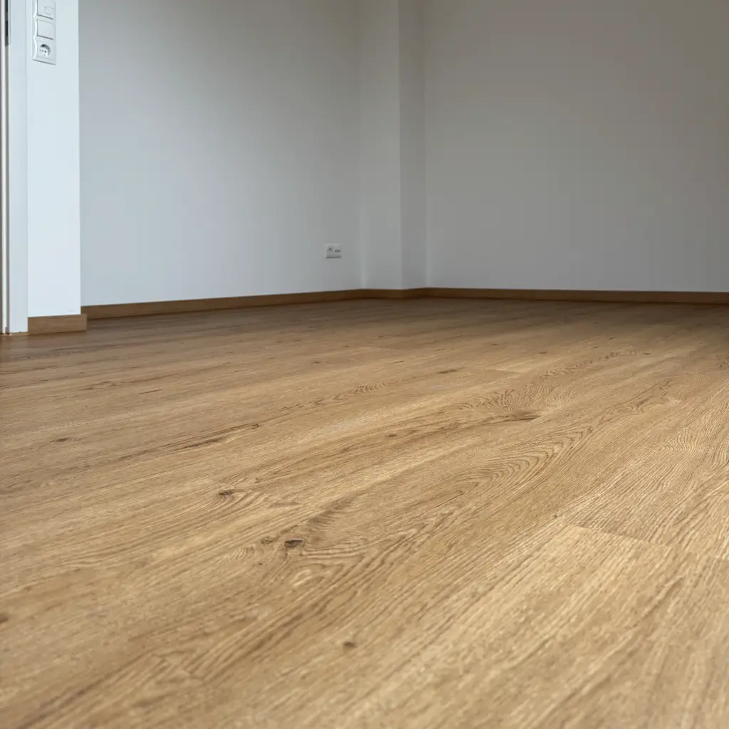 Klebevinylboden in warmer Holzoptik mit passenden Sockelleisten
